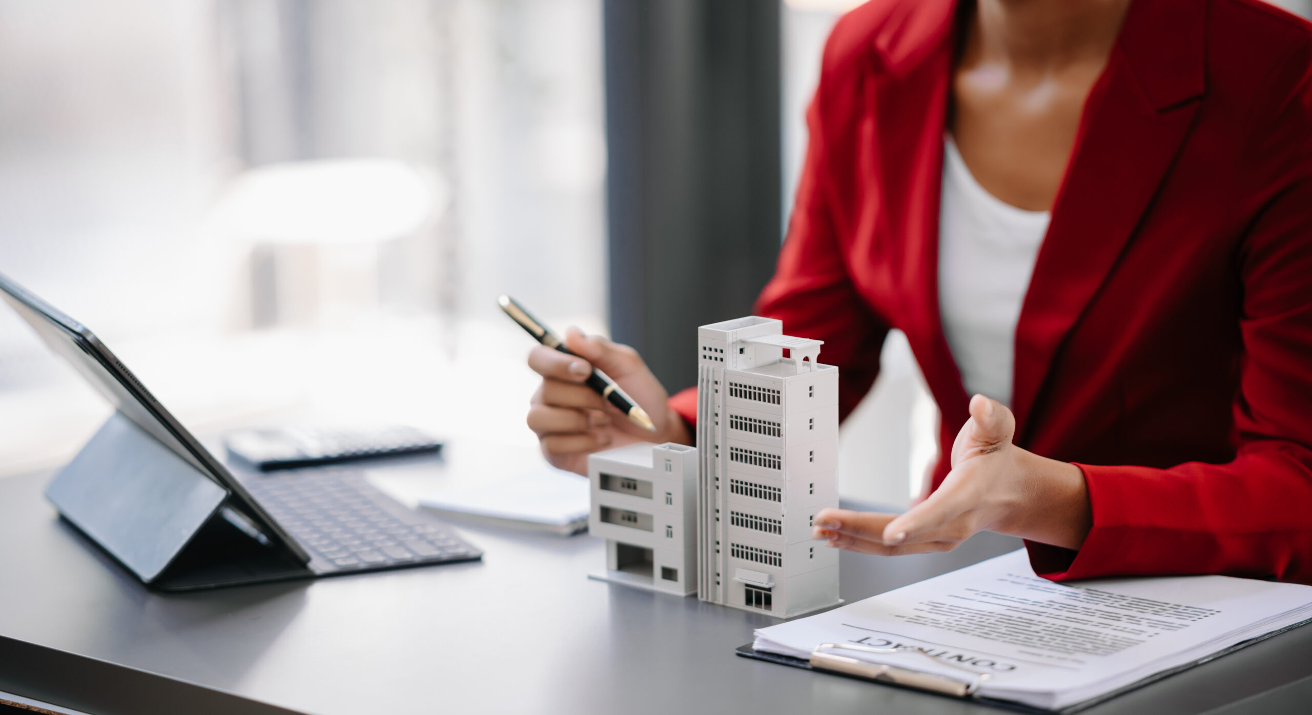 Real estate broker agent presenting and consult to customer to decision making sign insurance form agreement, home model, concerning mortgage loan offer