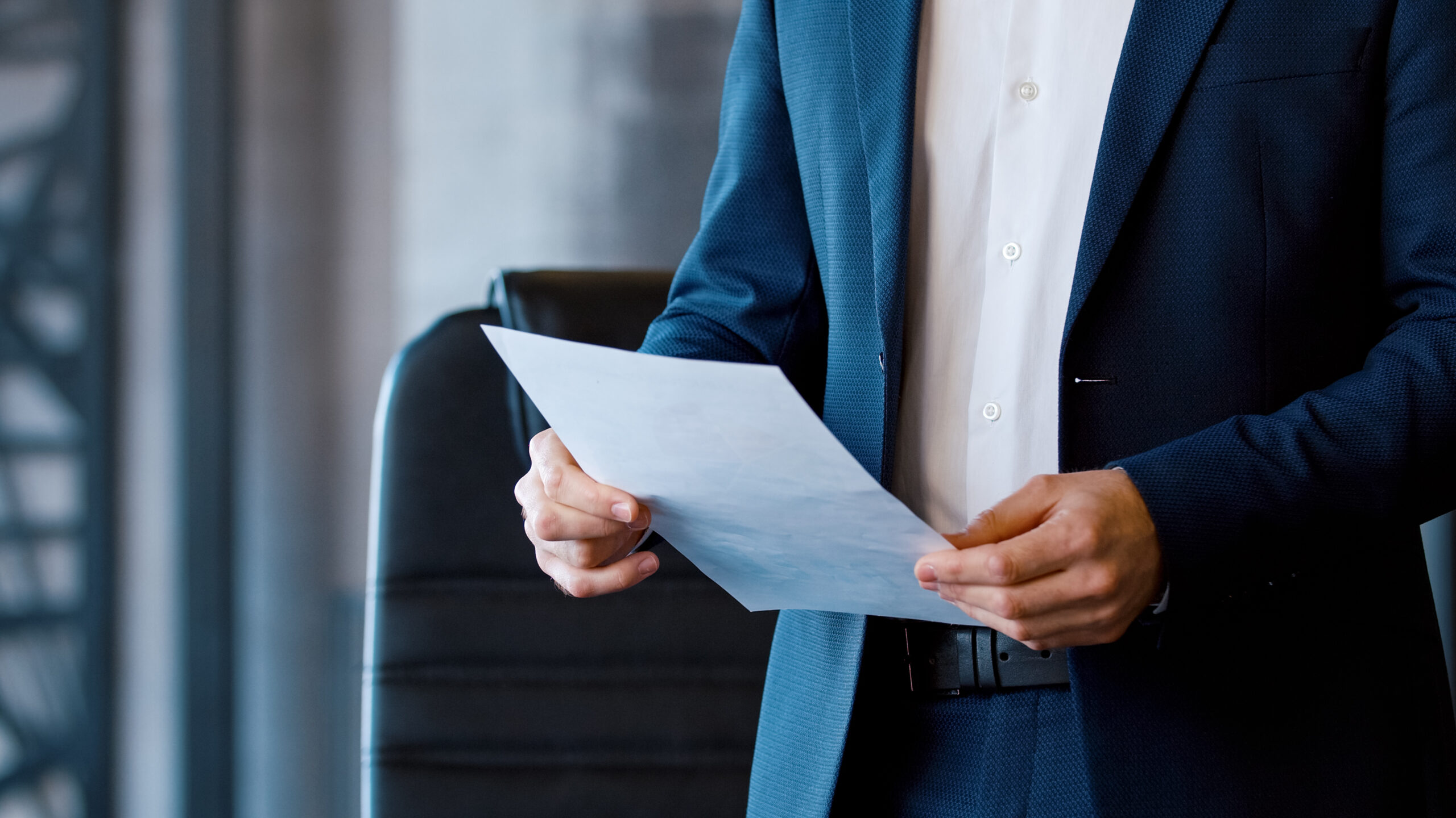 Young corporate leader in a suit at a business meeting in a workspace